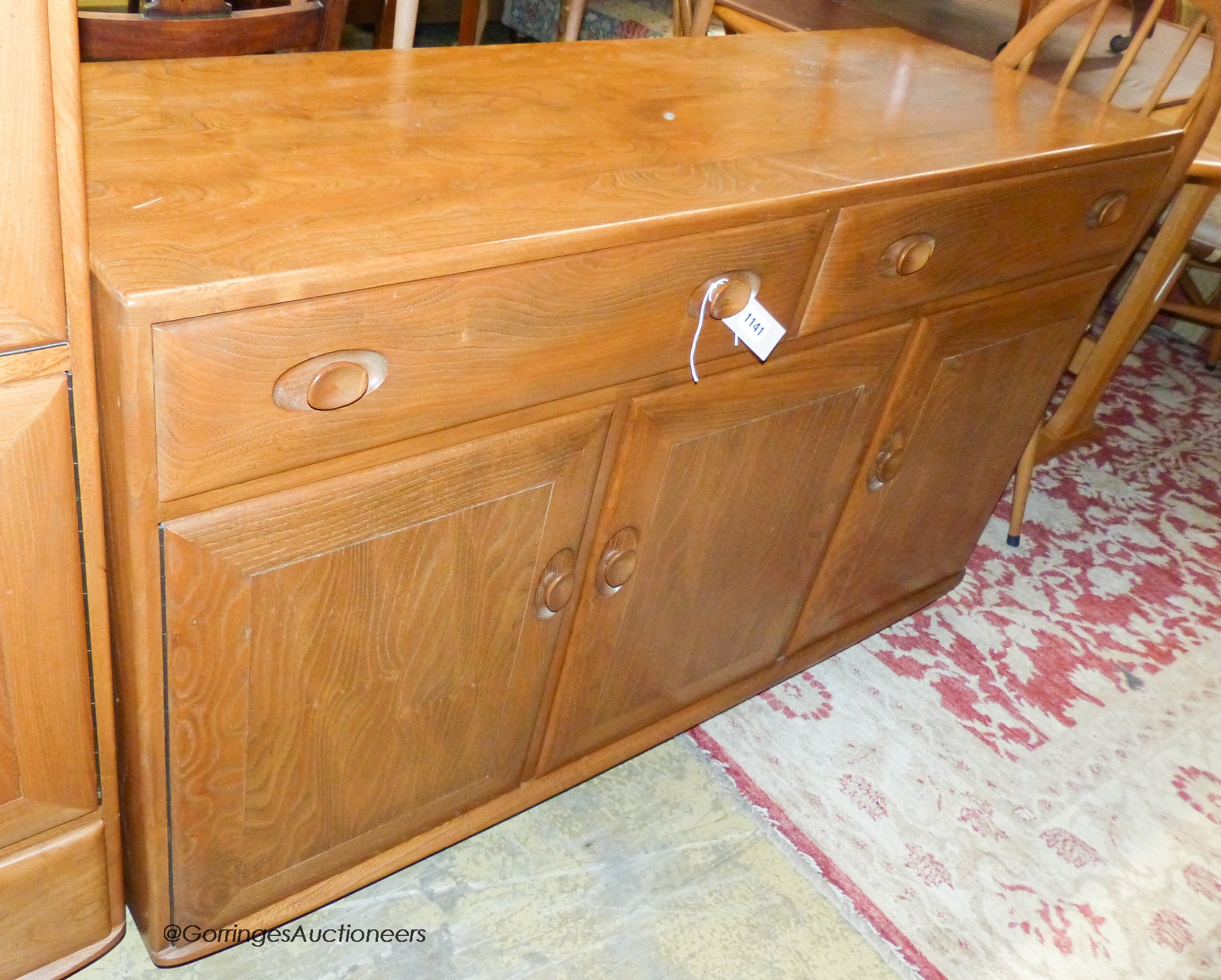 An Ercol elm Windsor sideboard, length 136cm, depth 46cm, height 81cm